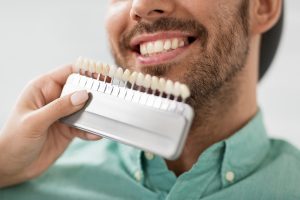 A man comparing dental veneers