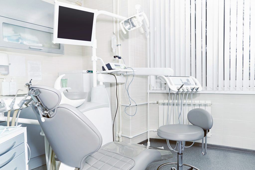 A dental office with instruments and chair